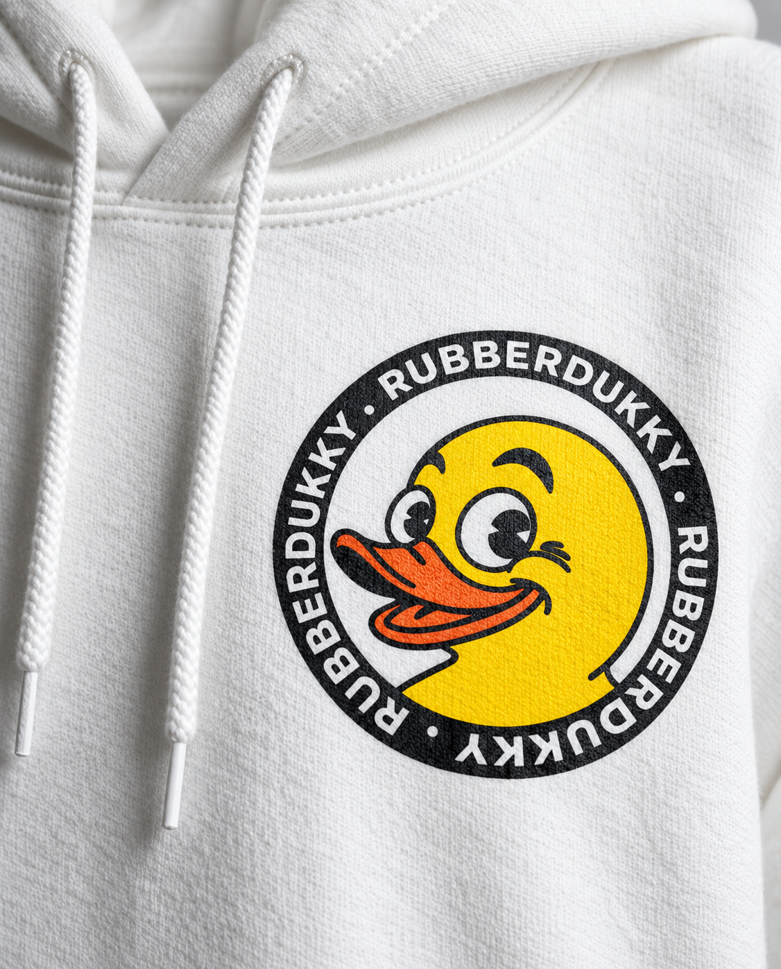 Close view of duck emblem on front of Doodledukky 2 white hoodie