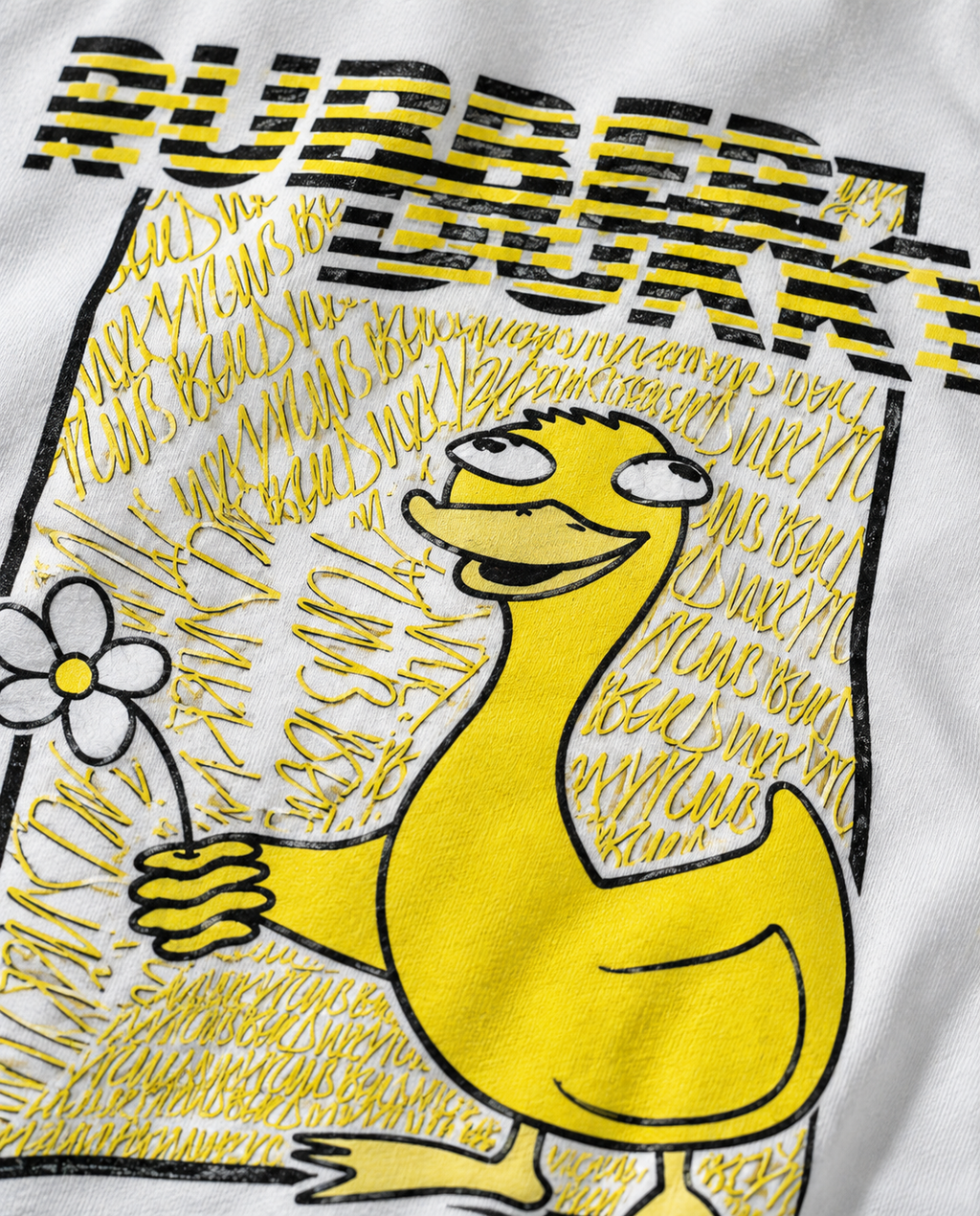 Close view of duck and flower artwork on white tee